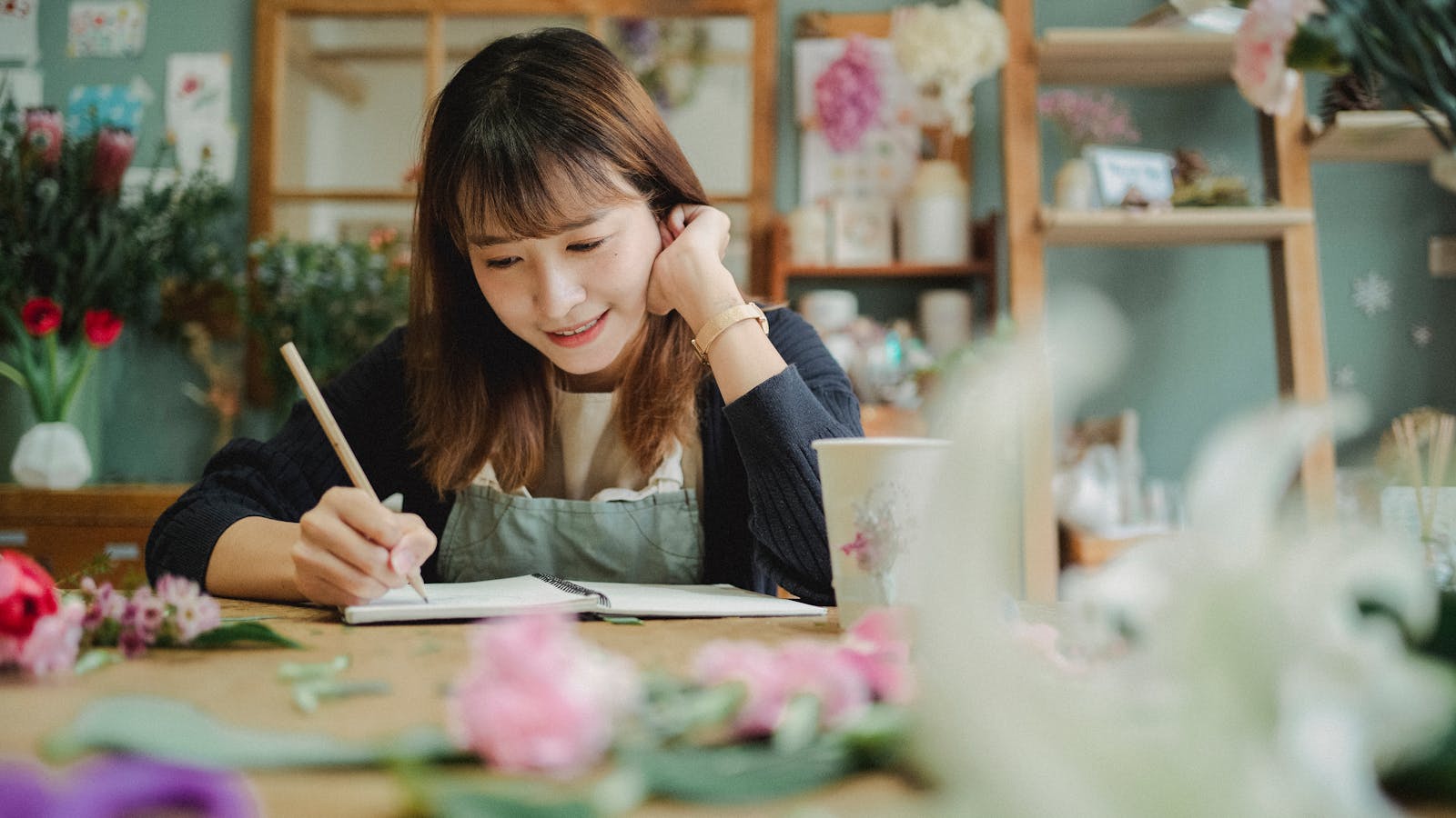 Self-employed small business owner working in her shop, representing Florida's self-employed health insurance options for 2026