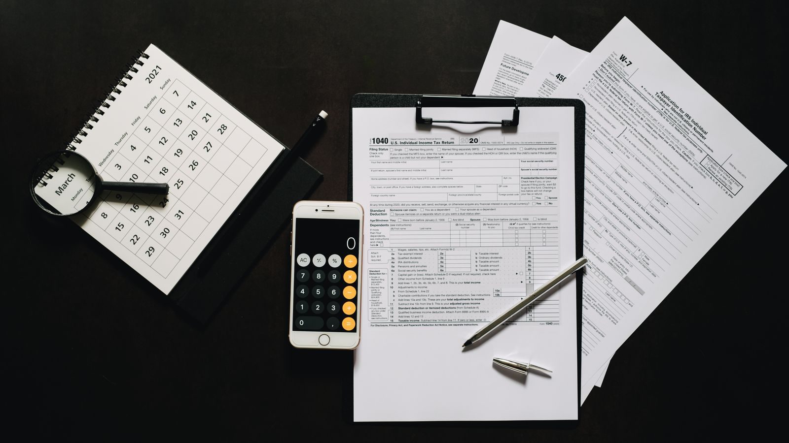 Tax forms and a calculator used to reconcile advance premium tax credits on a Florida ACA Marketplace return